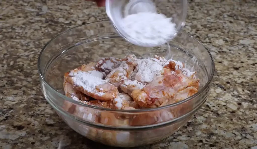 Adding the cornstarch to crispy air fryer lemon pepper wings 